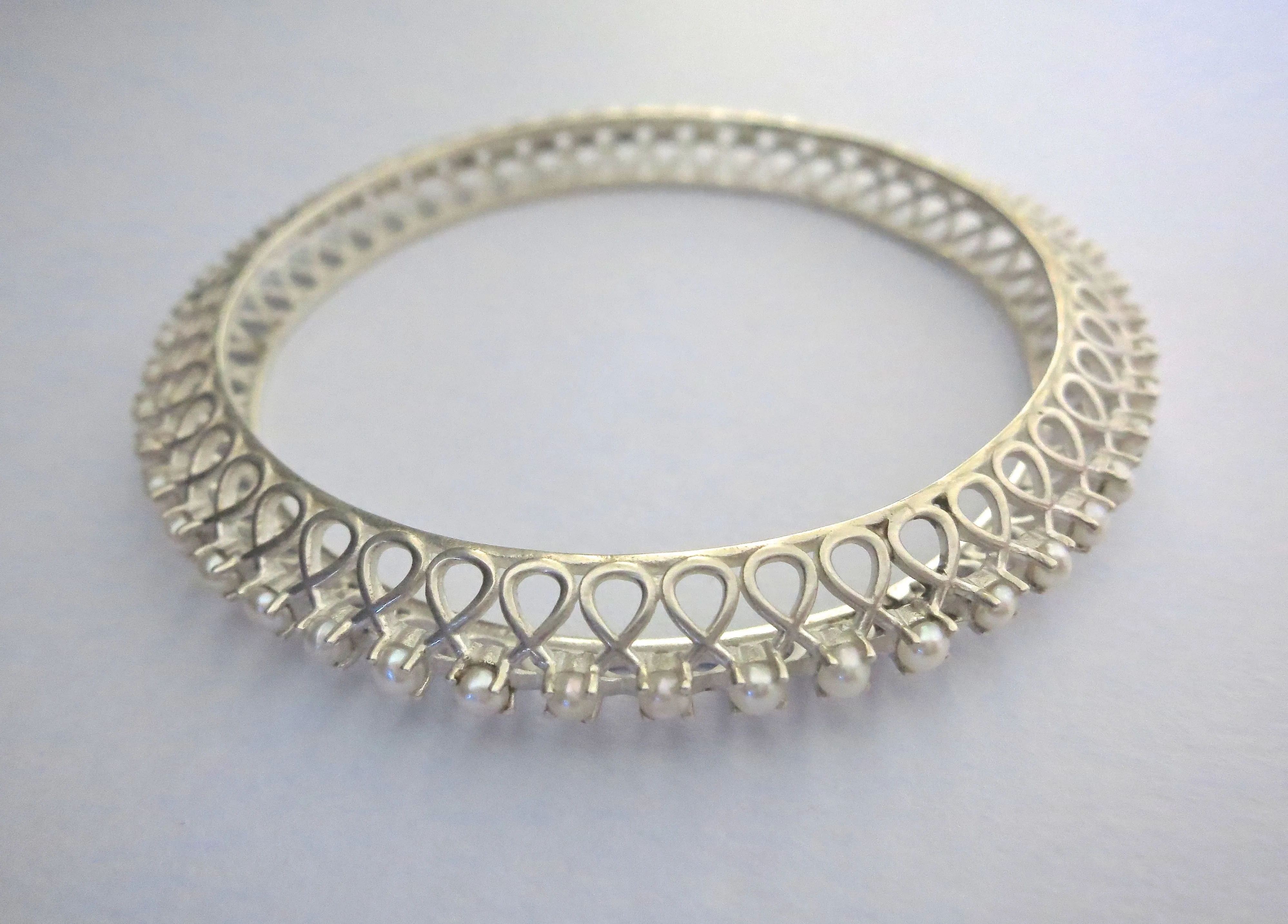 Classic and timeless, pearl encrusted statement bangle